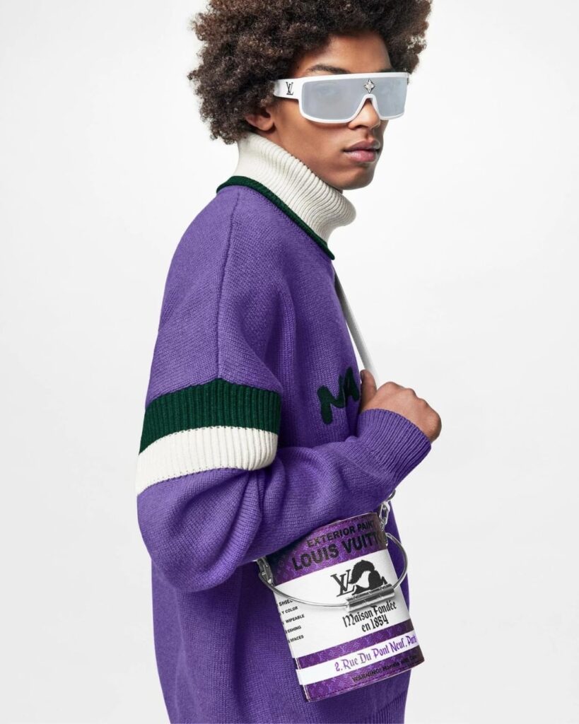 Male model with the purple Louis Vuitton Paint Can bag ispired by Kidult aesthetics 