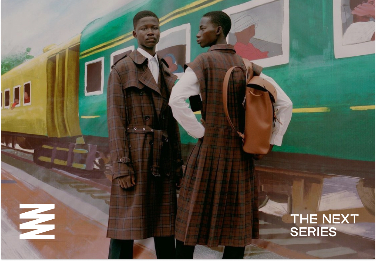 two african models posing in a train station